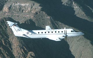 An Airforce C-12 shown in flight housing an onboard avionics test lab.